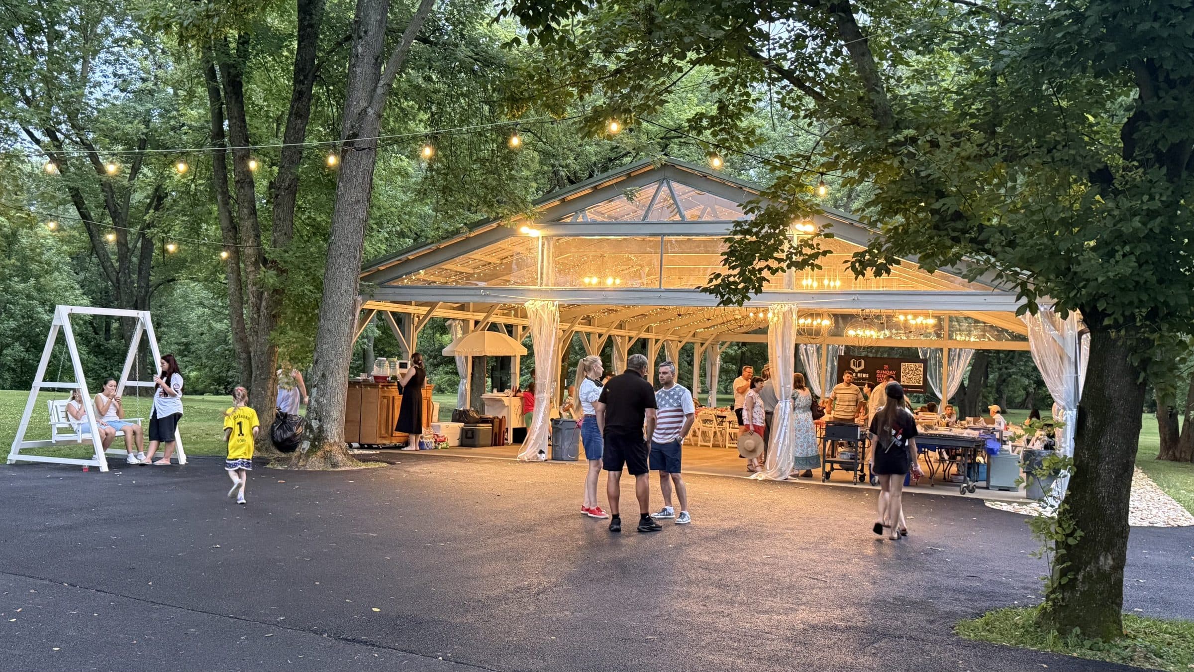 Church members gathered under the park shelter at sunset