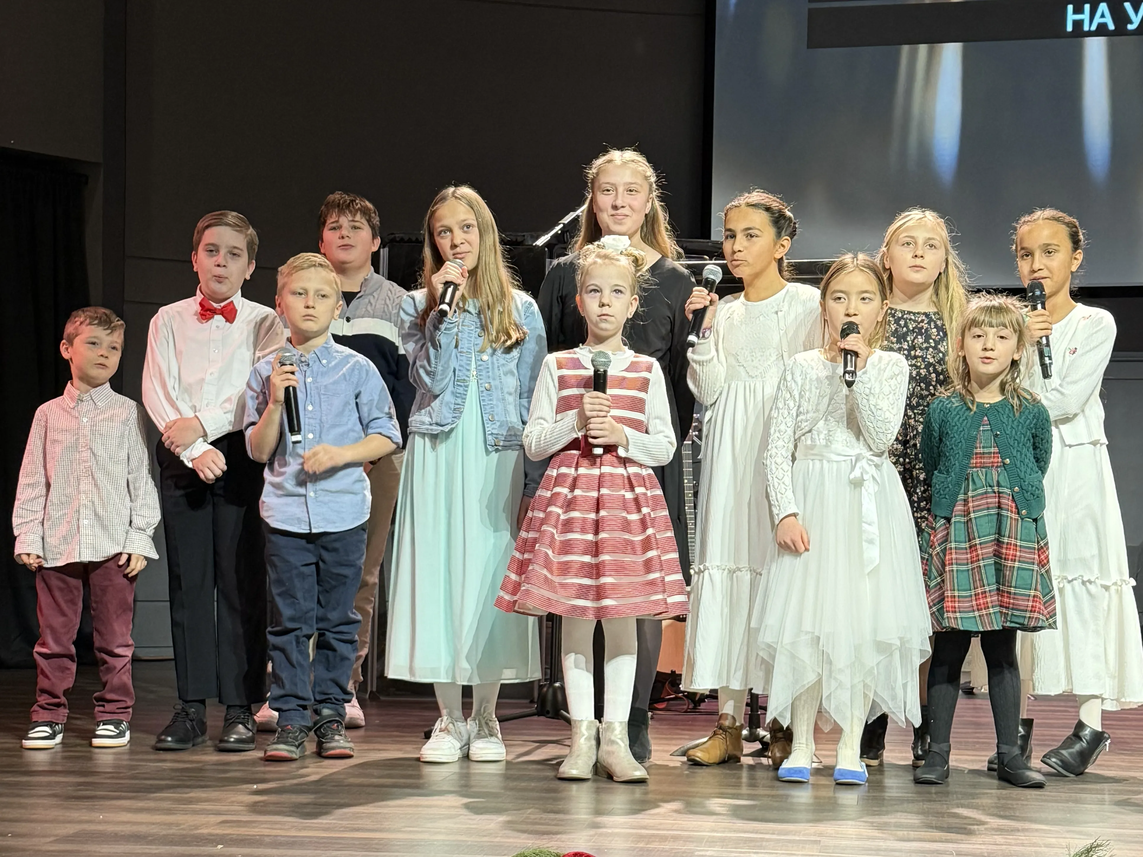 Children singing on stage at a church celebration