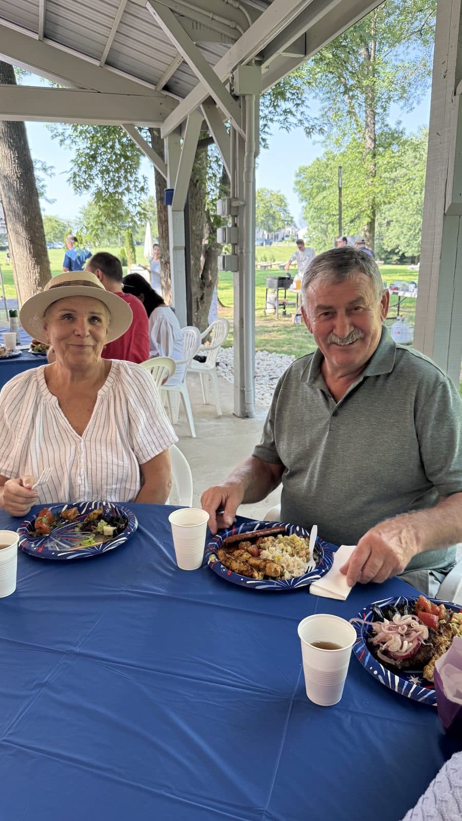 A couple enjoying a meal under the picnic shelter